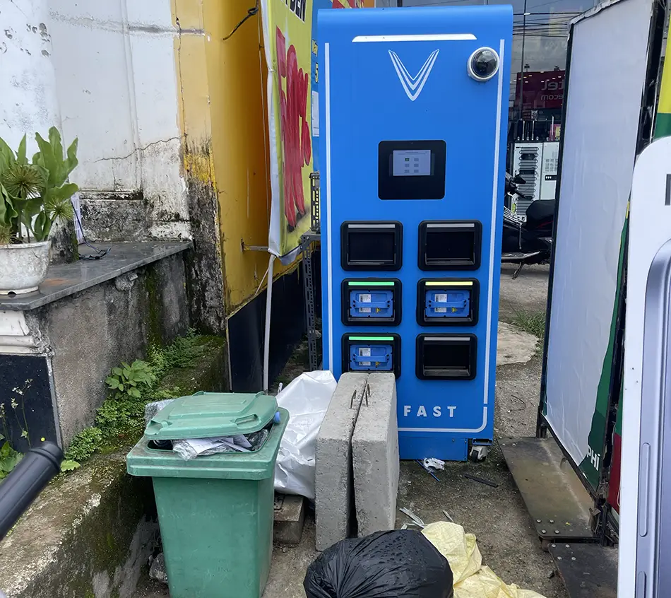 A scooter battery swapping station cluttered with junk