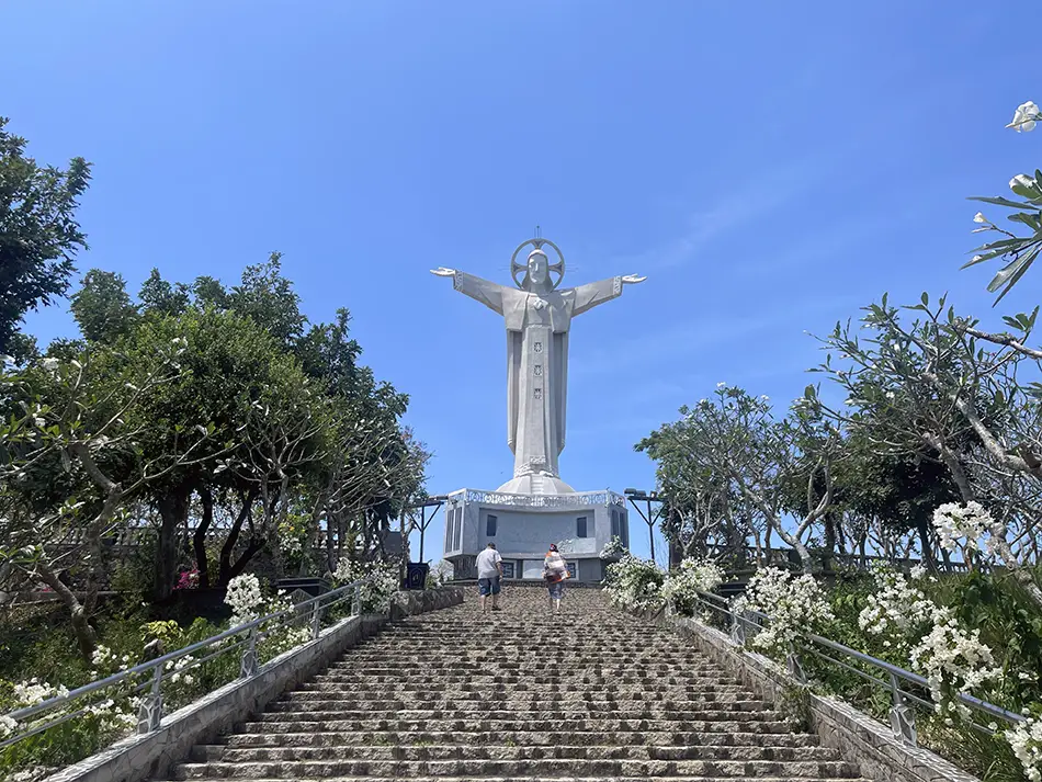 The Christ of Vung Tau statue viewed from the stairway leading up Small Mountain, the central attraction on a Vung Tau day trip from Ho Chi Minh City.