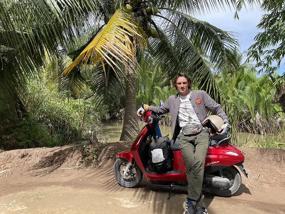 Yuriy Malykh with his electric scooter in Mekong Delta