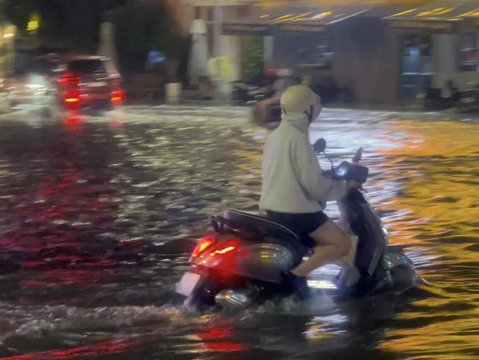 Motorbike driving through flooded streets of Phantiet