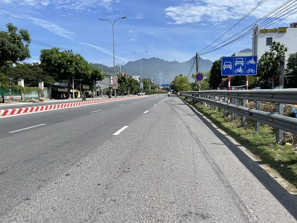 A road in Vietnam approaching mountains in the foreground near the Hai Van Pass.