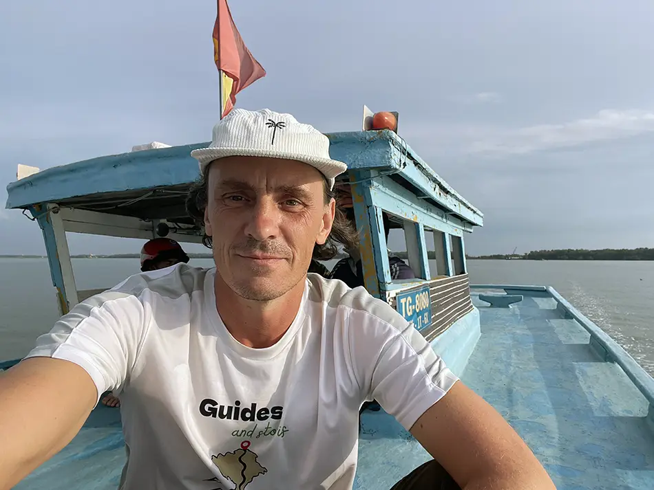 Yuriy Malykh on board of the boat crossing Mekong River