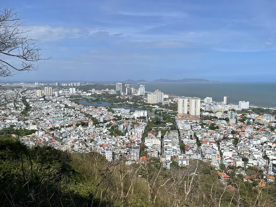 Vung Tau low-rise rooftops and coastline seen from Small Mountain.