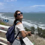 Traveler at a railed viewpoint above the Vung Tau coastline.