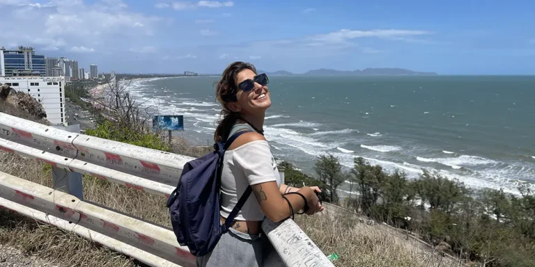 Traveler at a railed viewpoint above the Vung Tau coastline.