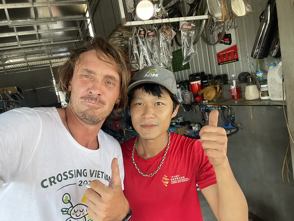 Yuri Malykh with a mechanic in a Vietnamese garage.