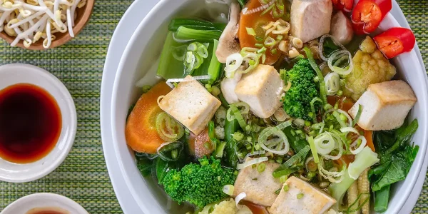A bright bowl of tofu, noodles and vegetables showcasing vegetarian food in Vietnam.